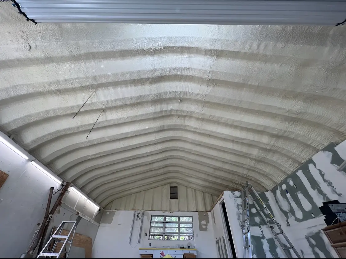 Spray polyurethane foam applied to the underside of a metal roof deck in Roseville